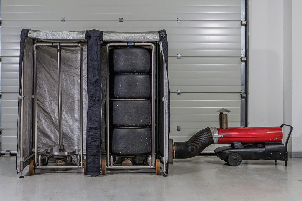 A tyre oven in a garage with a stack of tyres in it